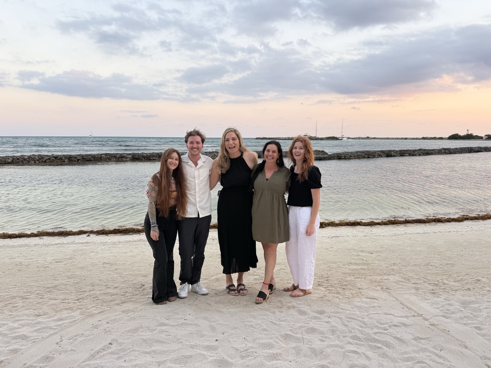 Qualia customer service team on the beach at sunset in Mexico